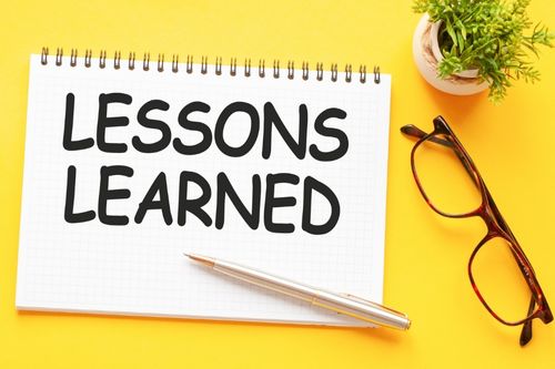 Lessons learned sign on yellow background