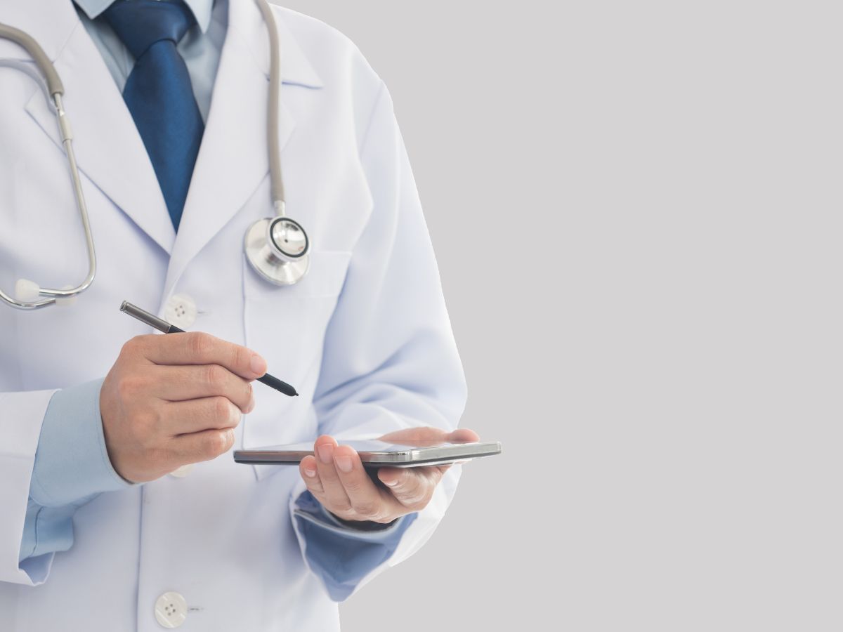 Physician Entering Notes on Tablet