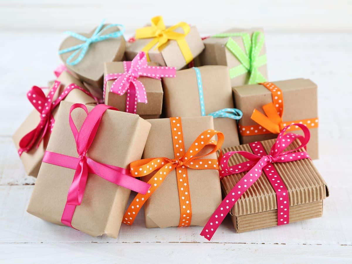 Pile of Gifts Wrapped in Brown Paper with Colorful Ribbons