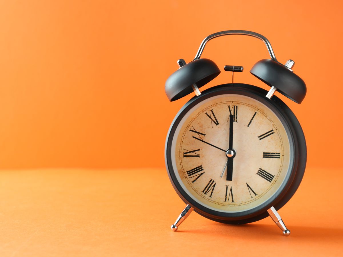 Old Fashioned Alarm Clock with Orange Background