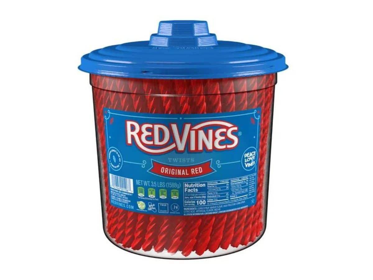 A clear container of Red Vines licorice with a blue lid