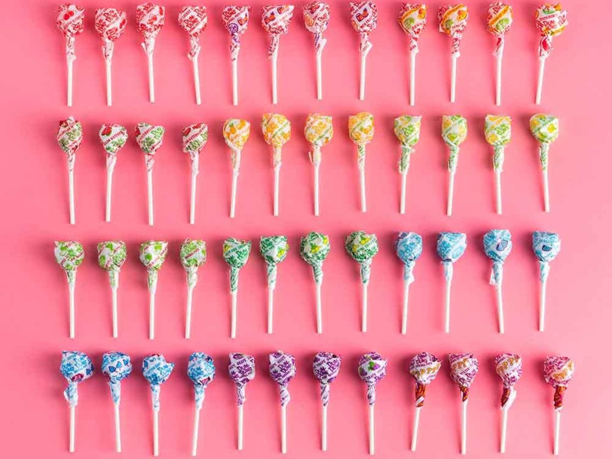Rows of Dum Dum Suckers on a Pink Background