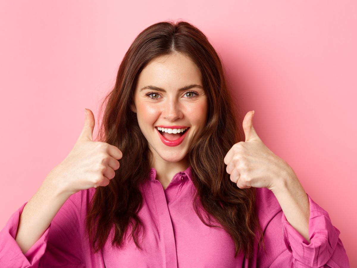 Woman in Pink Shirt with Thumbs Up