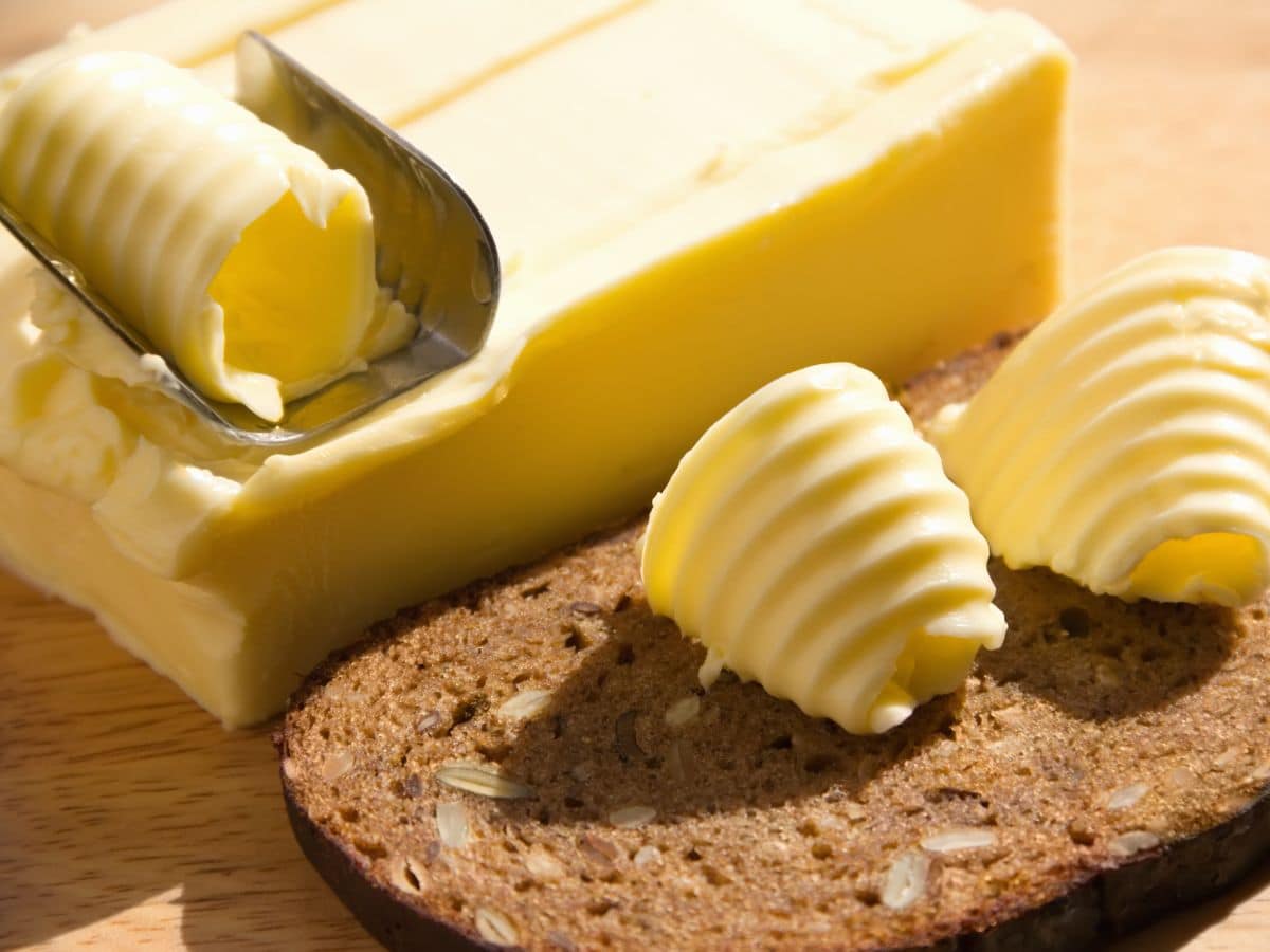 Elegant Rolls of Butter on a Piece of Hearty Bread