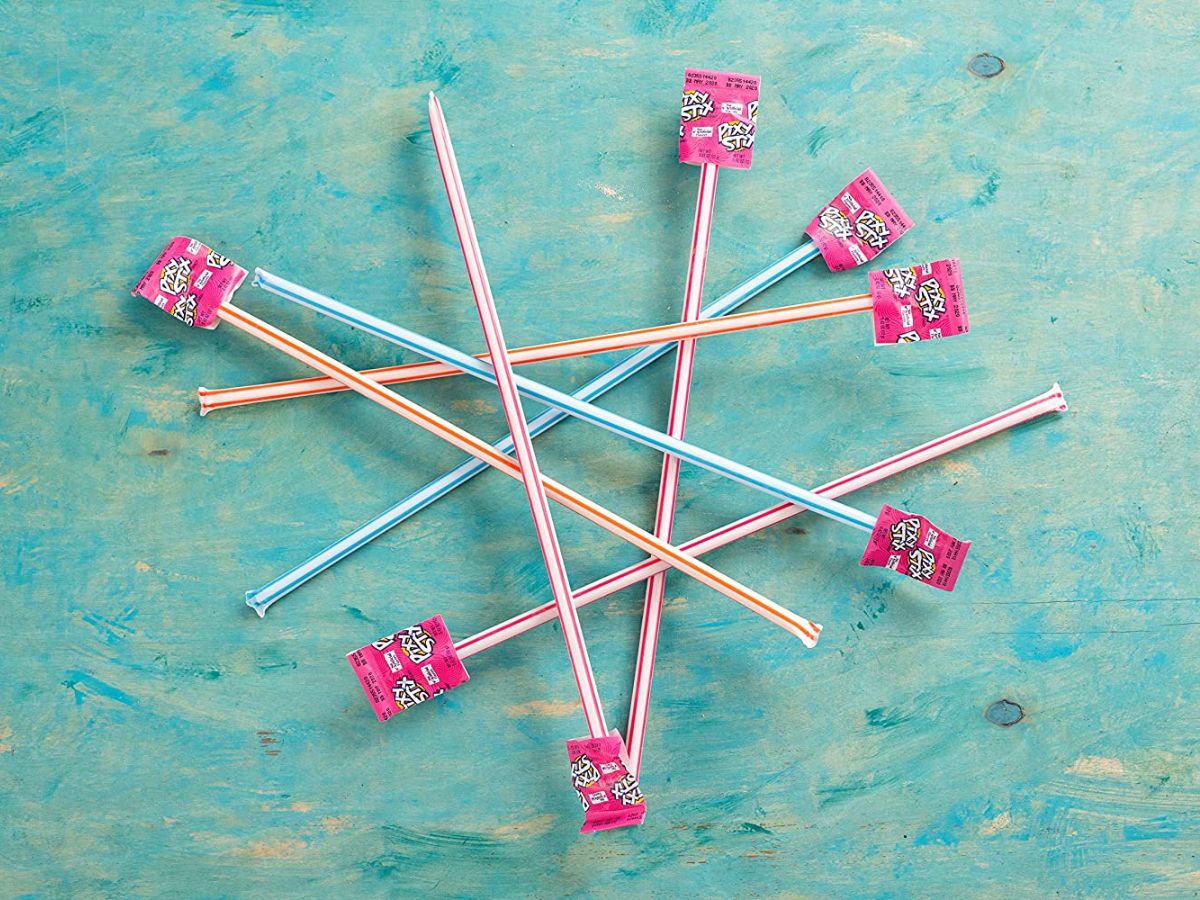 Pile of Pixy Stix candies on a green background