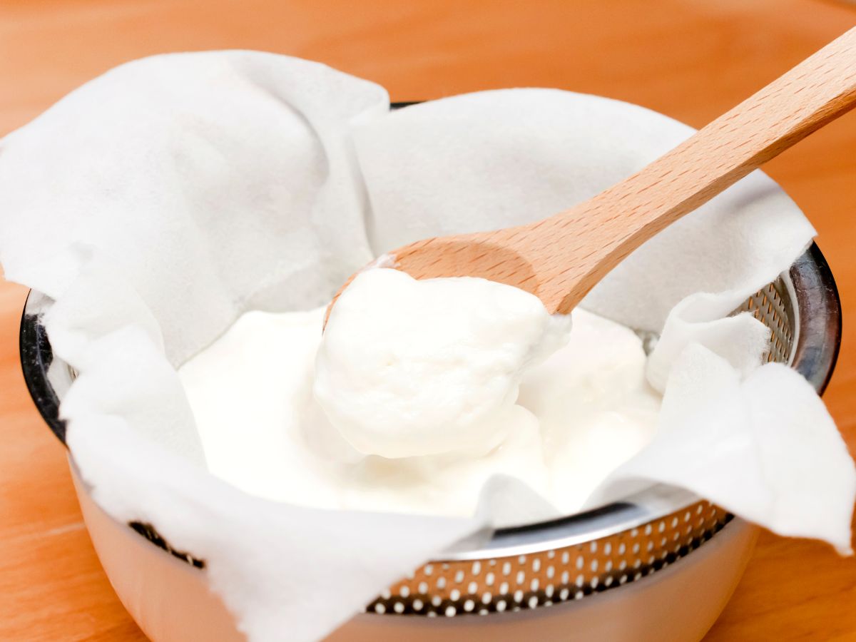 Bowl of Greek yogurt and a wooden spoon
