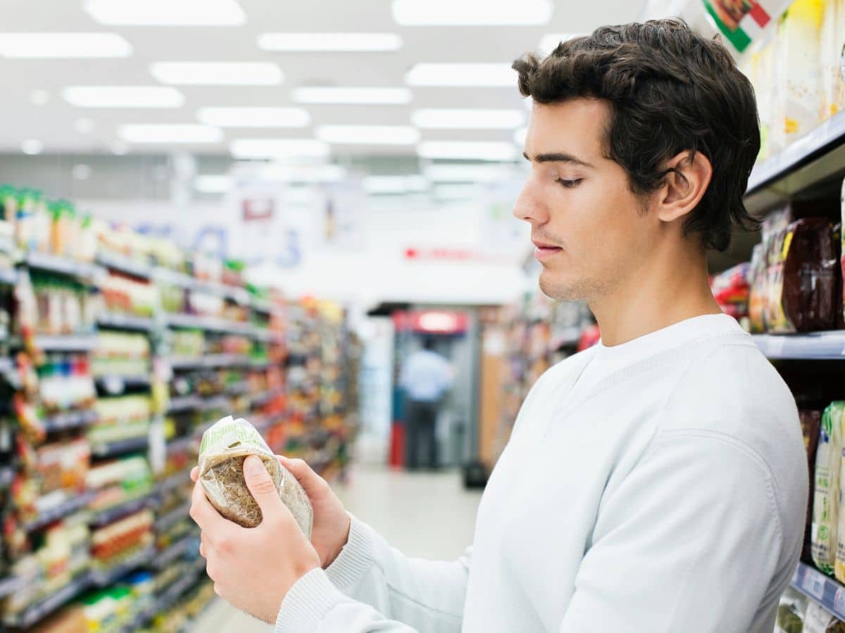 Man Reading a Food Label at the Grocery Store