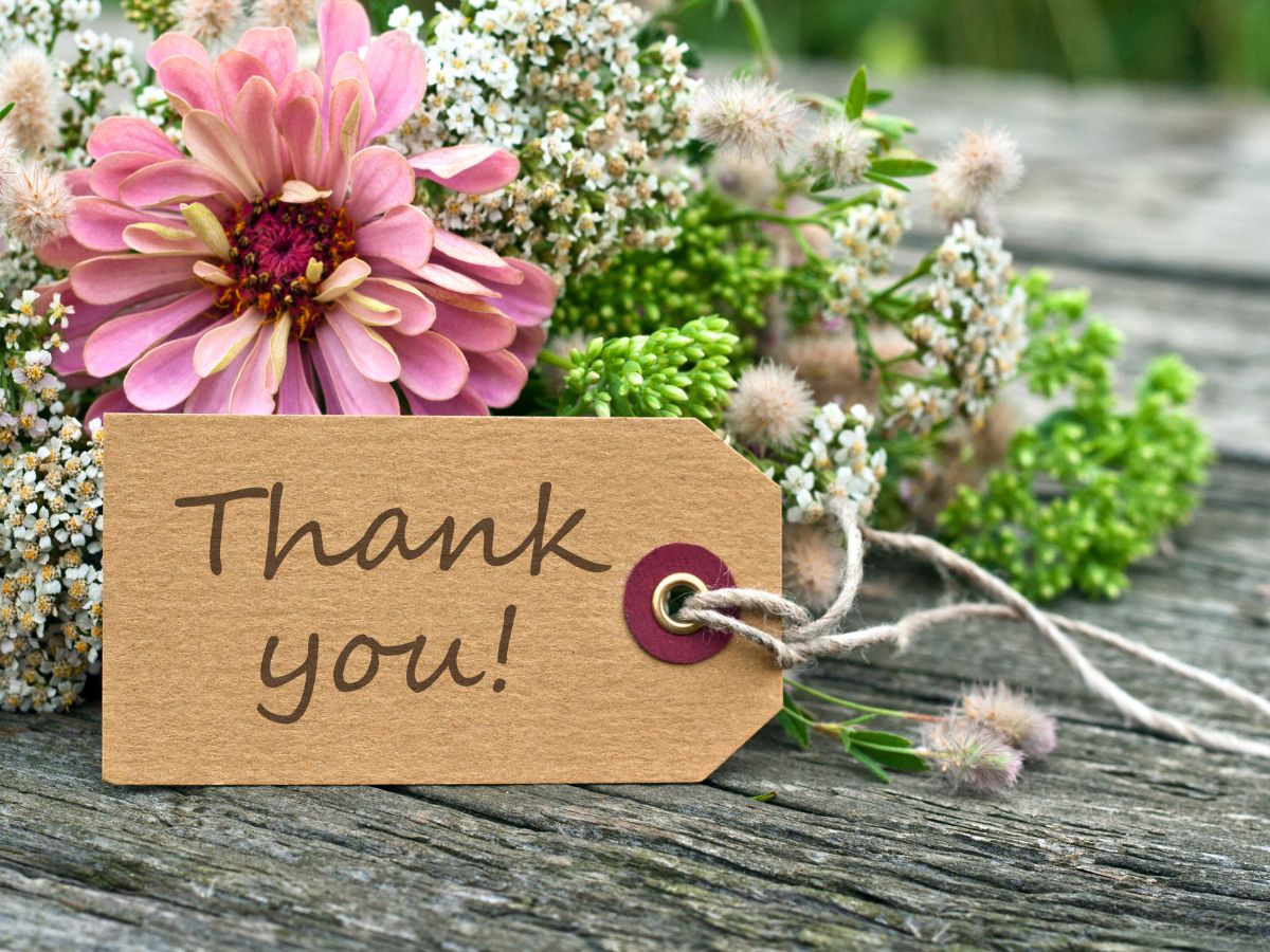 A bouquet of wildflowers with a "thank you" note attached