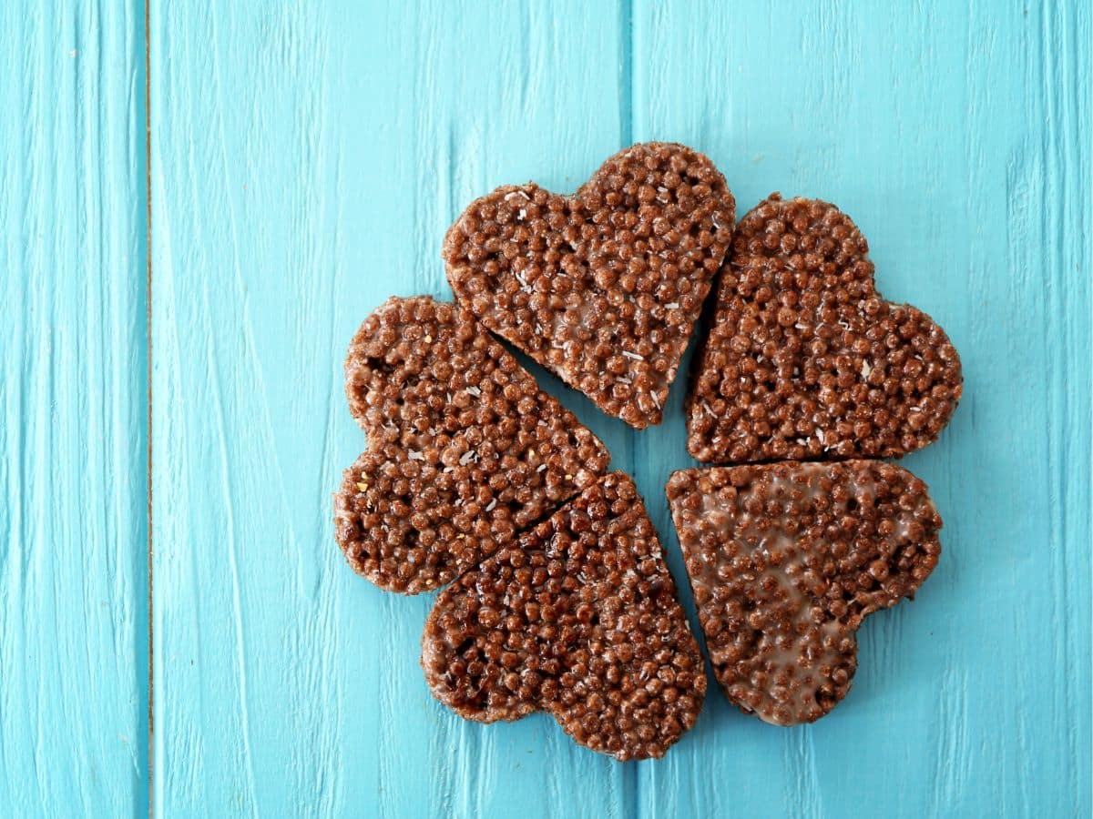 Cocoa Pebbles cut into hearts on a blue backdrop