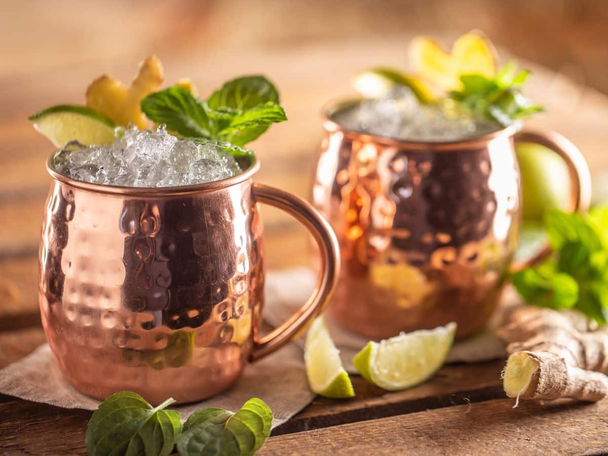 A pair of copper mugs filled with huckleberry vodka and ginger beer.