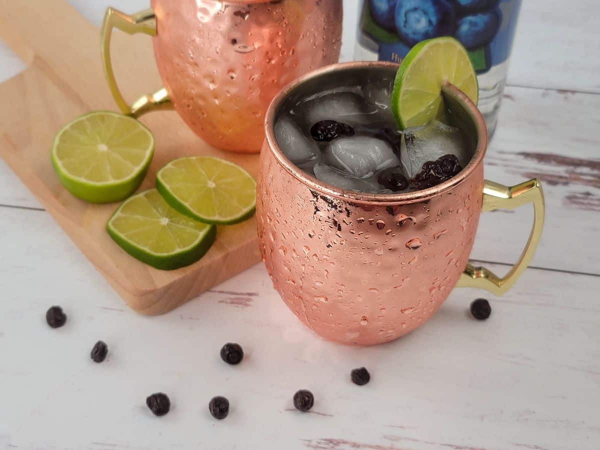 Two copper mugs filled with Montana mules, a Moscow mule variation made with huckleberry vodka