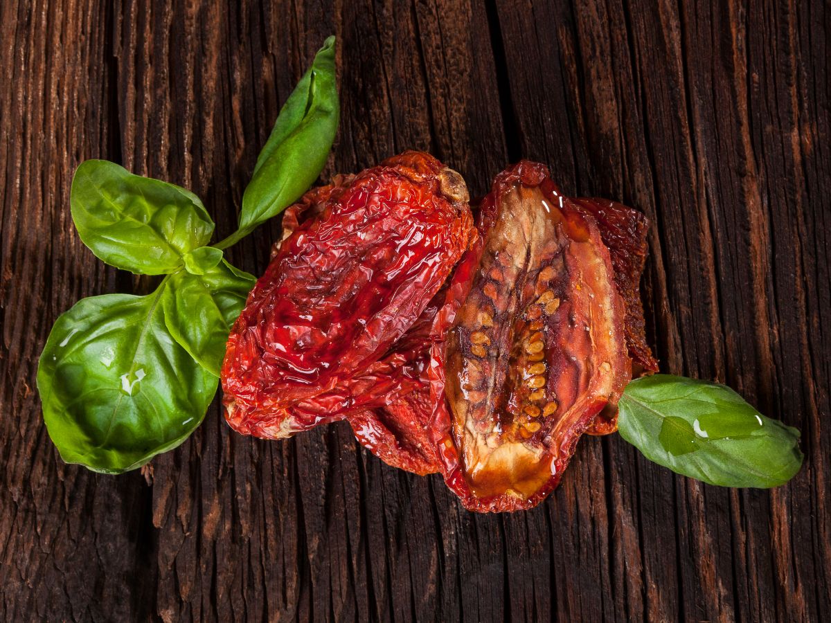 Sundried Tomatoes with Fresh Basil on a Wooden Table