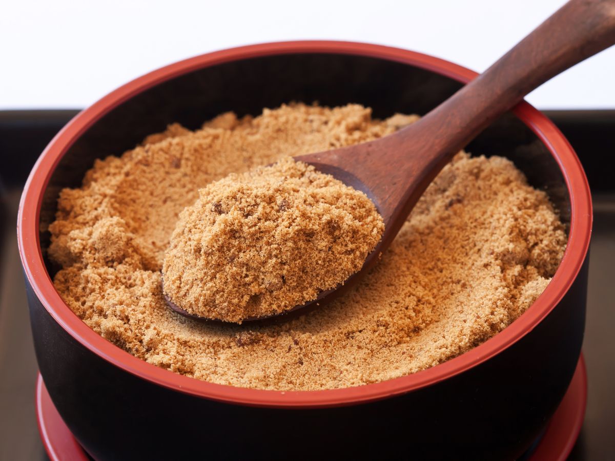 A bowl of brown sugar and a spoon
