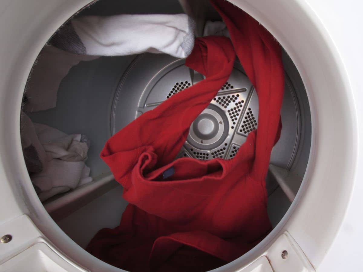 A red shirt tumbling in a clothes dryer