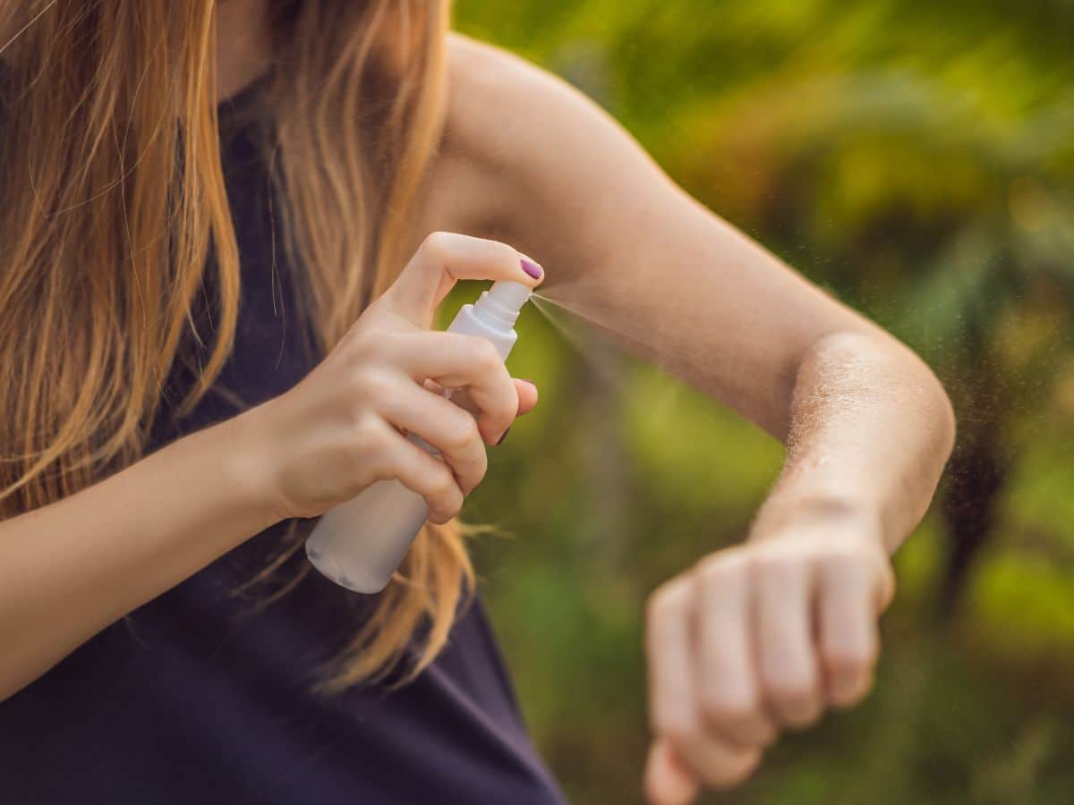 Woman Spraying Insect Repellent