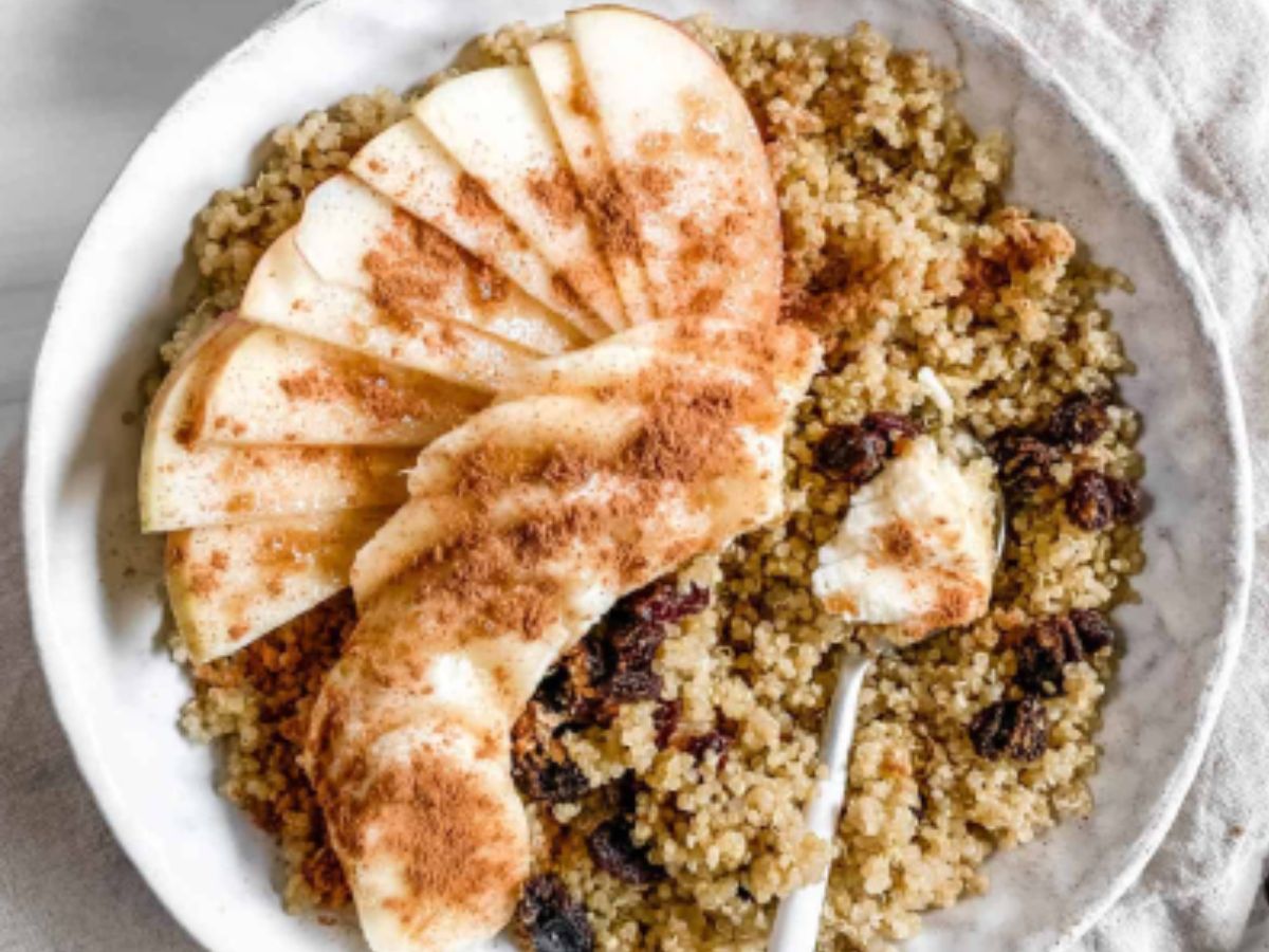 A bowl of quinoa with apples and raisins.