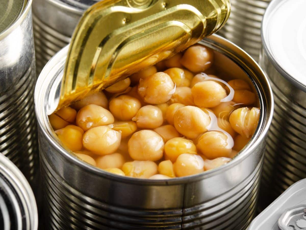 An open can of chickpeas ready to be drained and rinsed for quinoa salad.