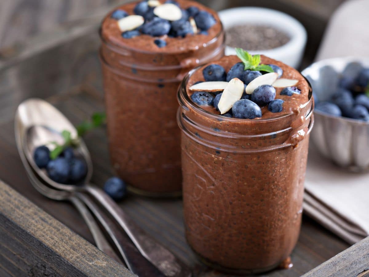 Chocolate Chia Pudding in Glass Mason Jars Topped with Blueberries.