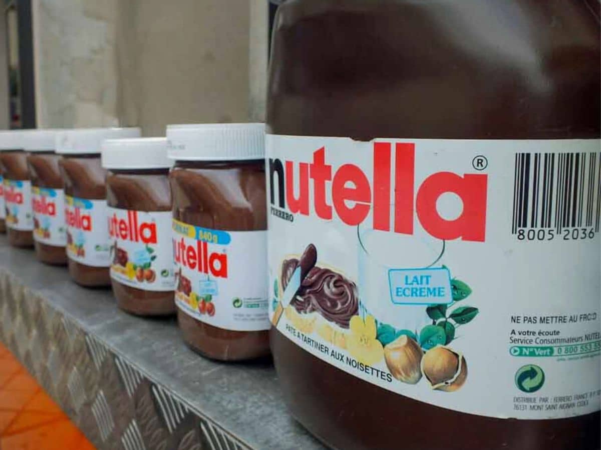 A row of Nutella jars sitting on a table in France.