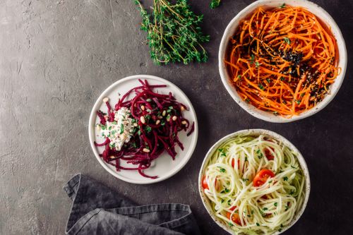 Three bowls of veggie noodles made with carrots, beets, and zucchini.