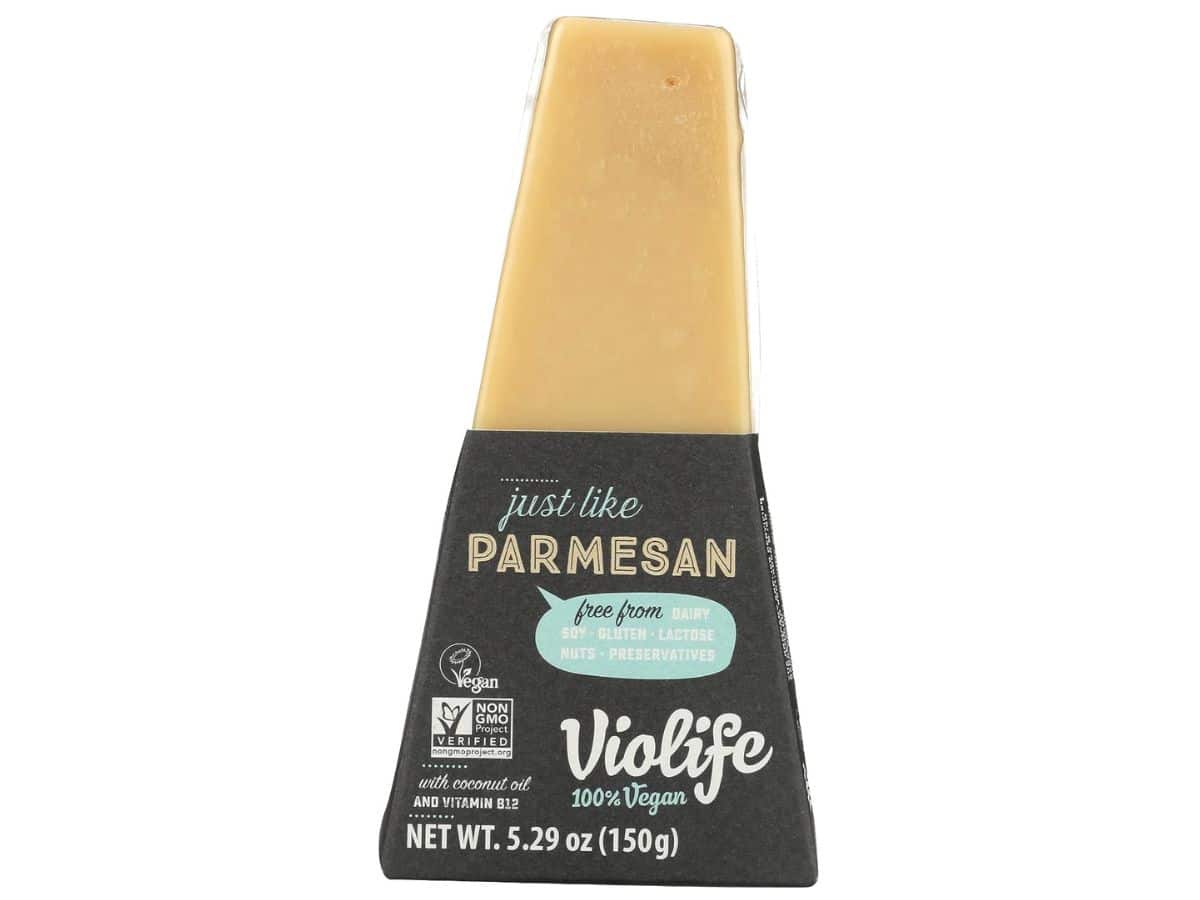 A piece of Violife vegan parmesan cheese on a white background.