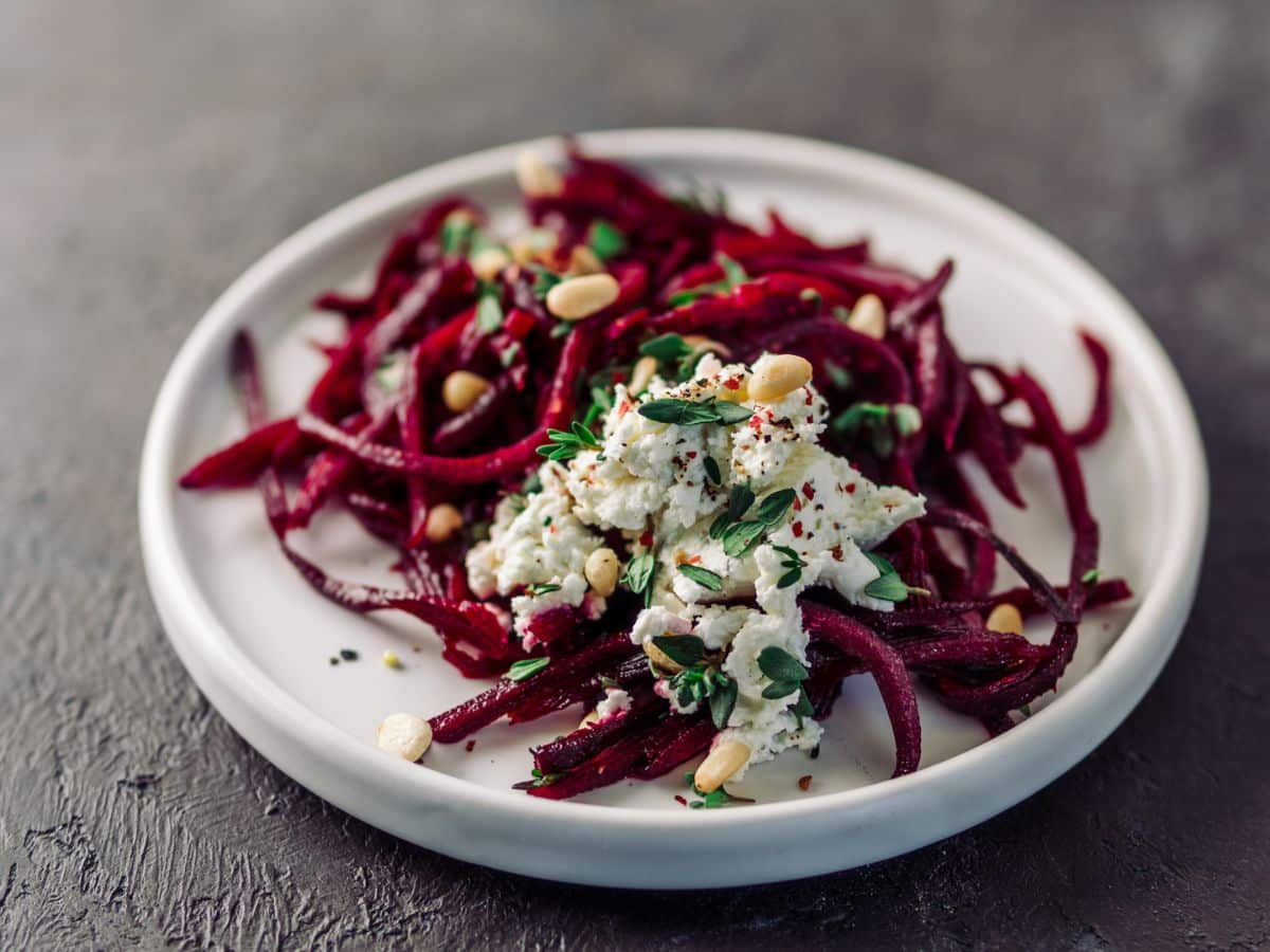 Beet salad with feta and nuts on a plate.