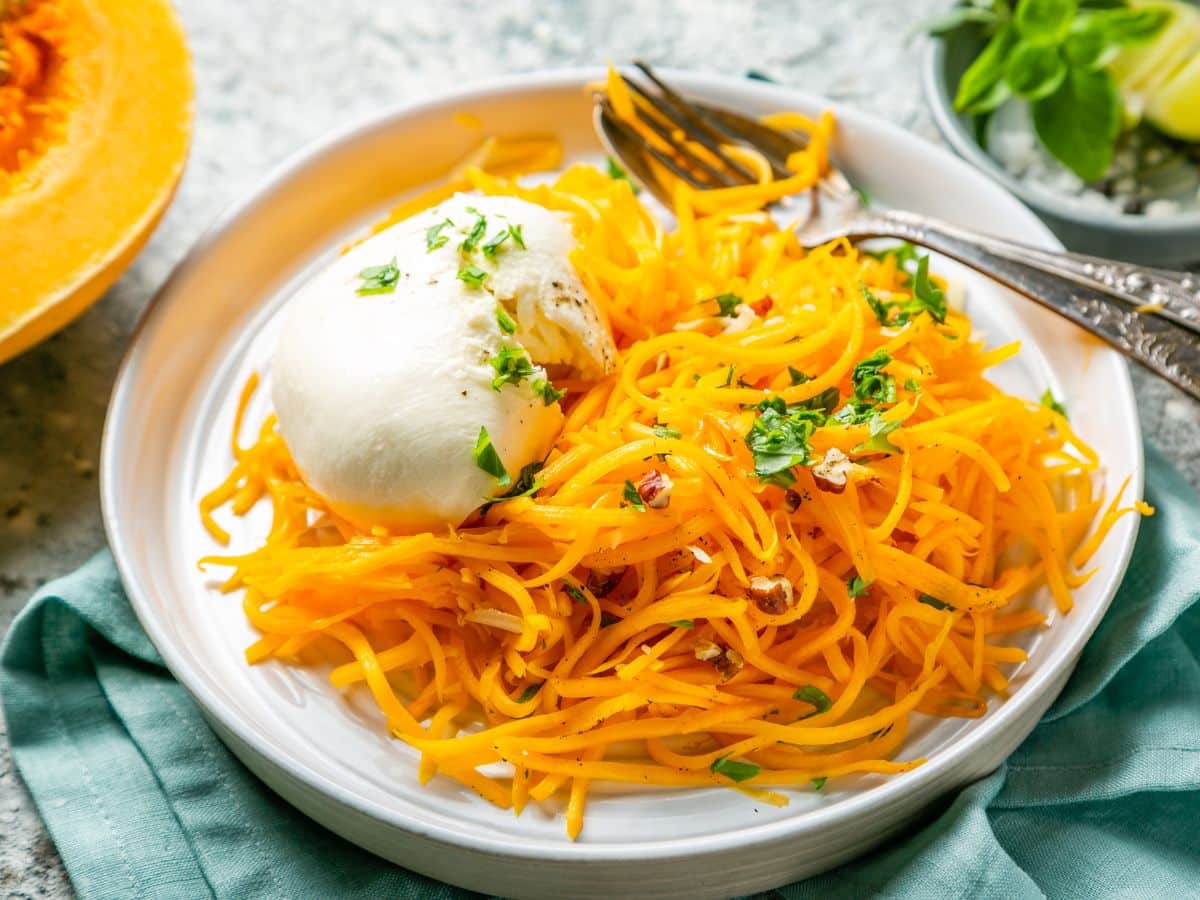 A plate of butternut squash with a scoop of ricotta cheese.