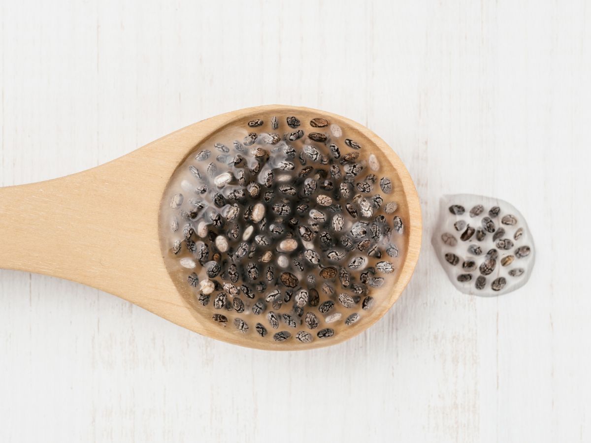 Chia seed egg replacement on a wooden spoon on a white background.
