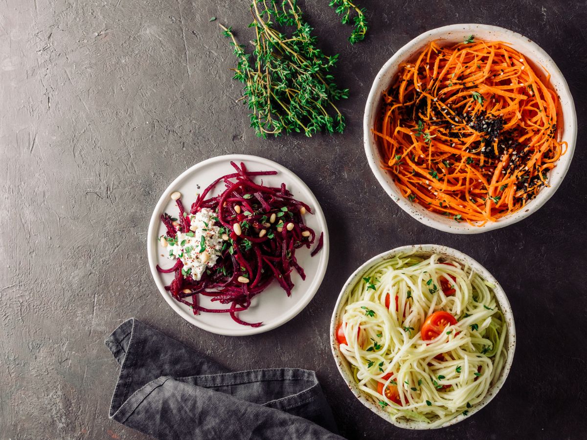 Three bowls of veggie noodles made from carrots, beetroot, and zucchini.