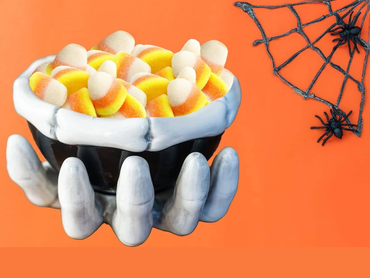 A bowl of gummy candy corn treats on a spooky background.