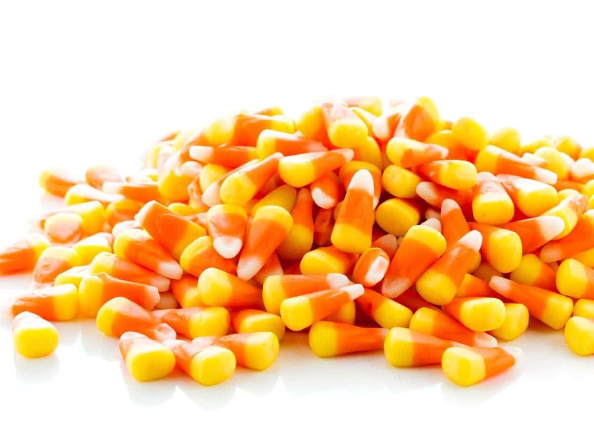 A pile of candy corn on a white background.