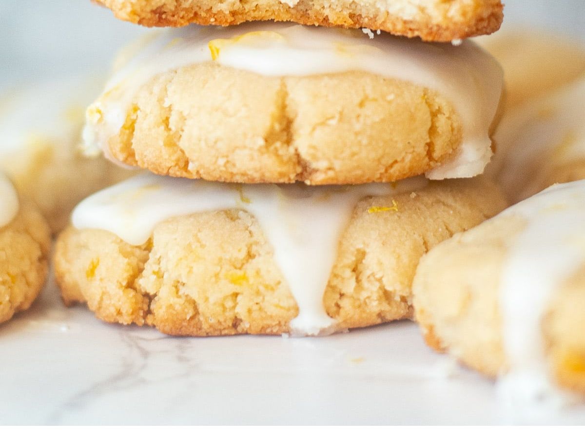 A stack of lemon cookies with icing on top.