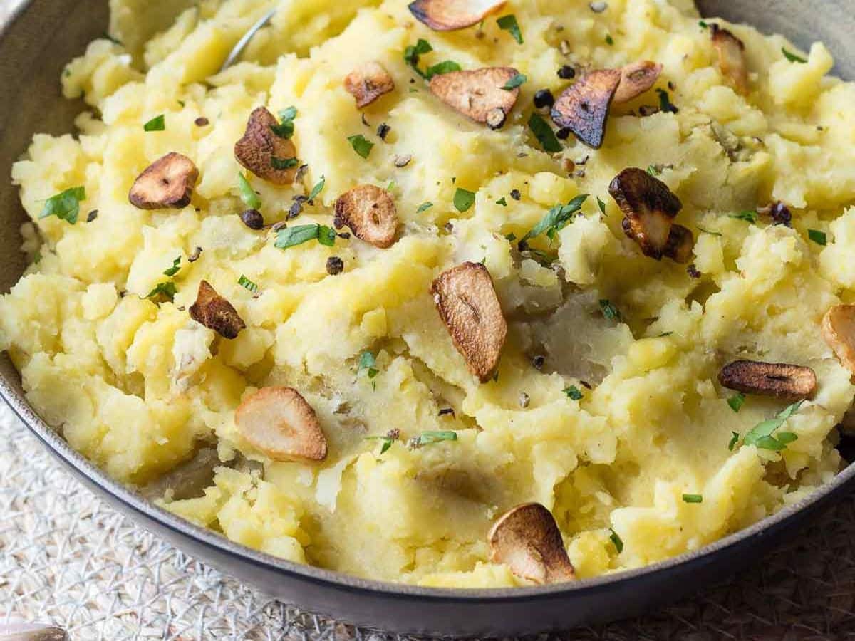 Dairy-free mashed potatoes with slivered mushrooms in a bowl.