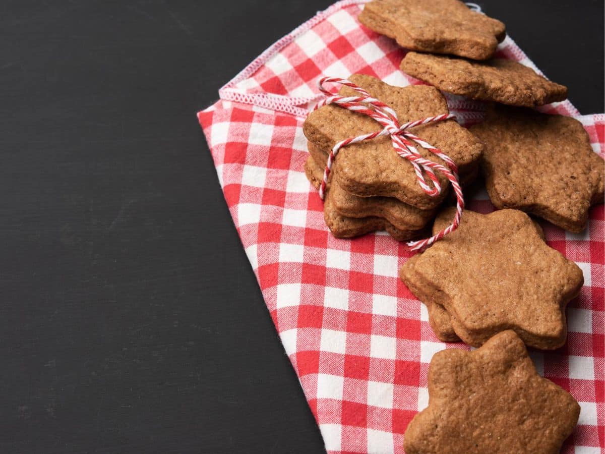 Gingerbread cookies on a red and white checkered napkin.