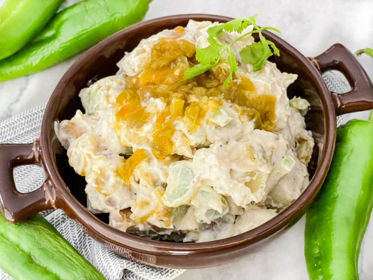 A bowl of potato salad with green peppers.