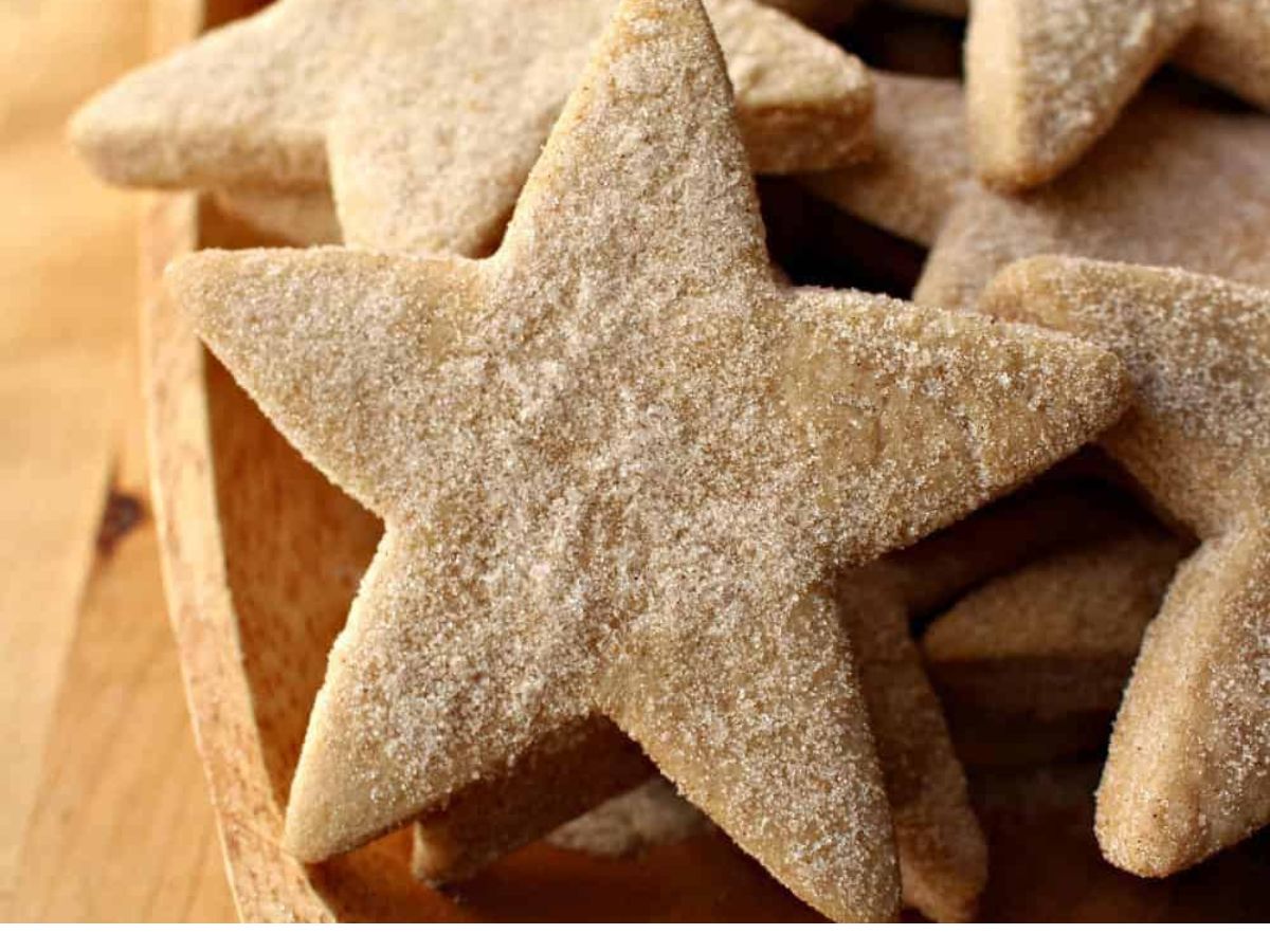 Star shaped sugar cookies in a wooden bowl.