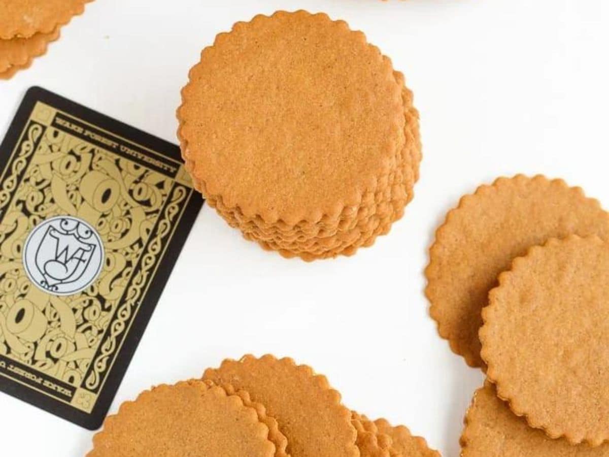 A stack of gingerbread cookies next to a playing card.