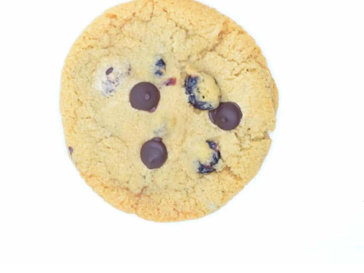 A chocolate chip cookie with chocolate chips on a white background.