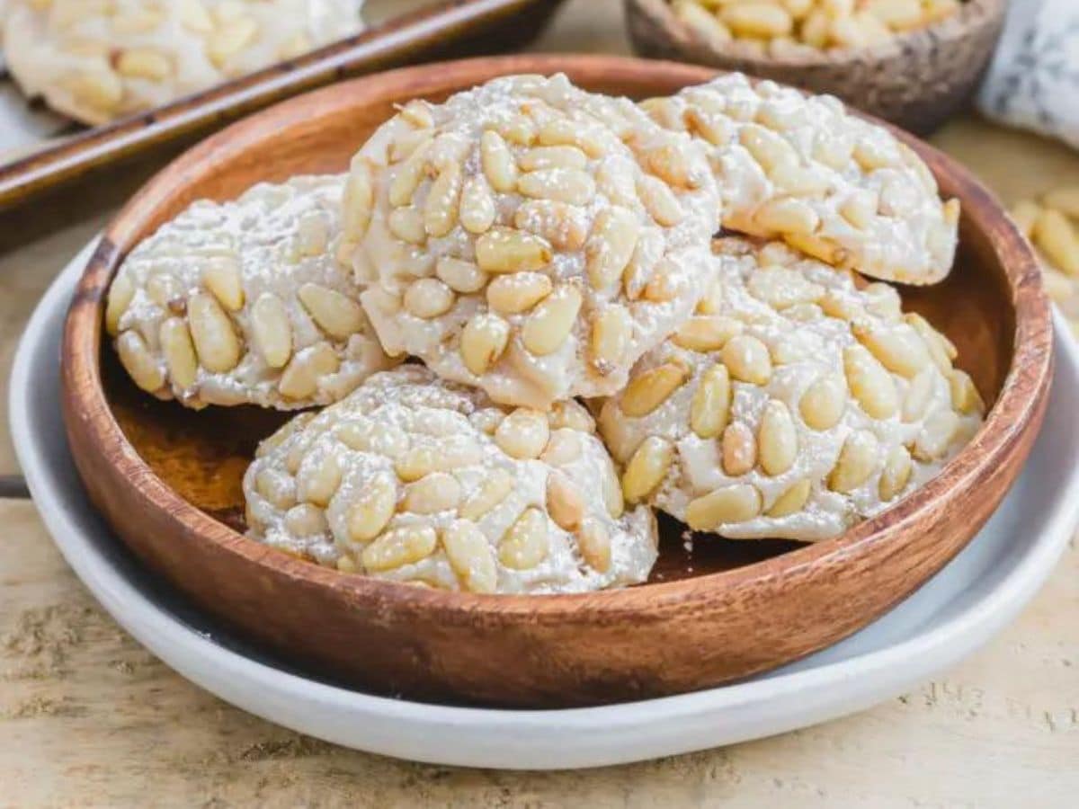 Pistachio cookies in a wooden bowl.