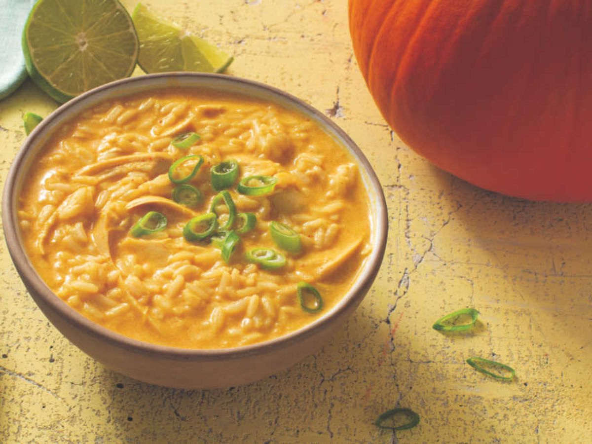 A bowl of turkey pumpkin curry soup with rice.