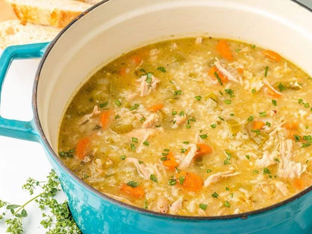 Turkey and rice soup in a blue pot.