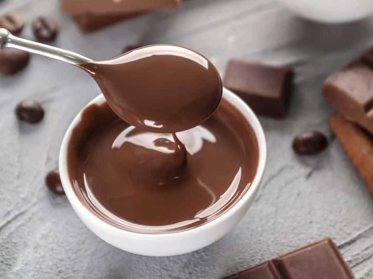 Discover how to melt chocolate using a spoon while pouring it into a cup.