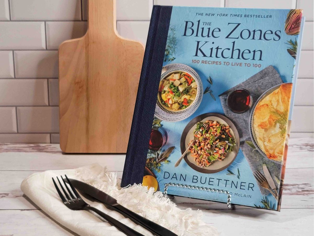 A copy of The Blue Zones Kitchen by Dan Buettner on a kitchen counter.