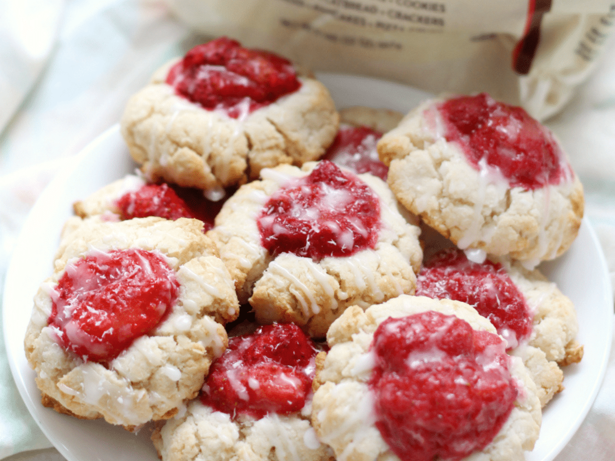 Vegan strawberry thumbprint cookies on a plate.