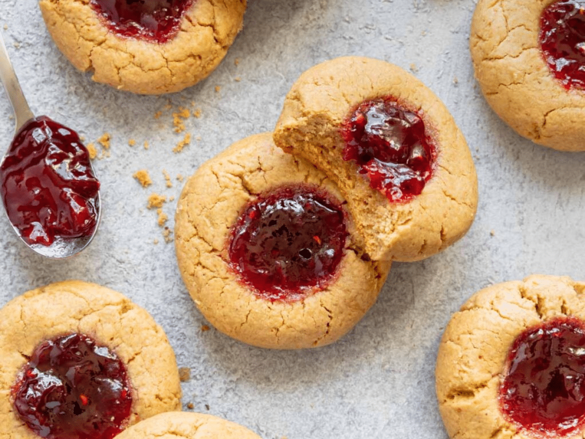 Vegan thumbprint cookies with jam and a spoon.