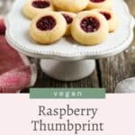 Vegan raspberry thumbprint cookies on a white plate.