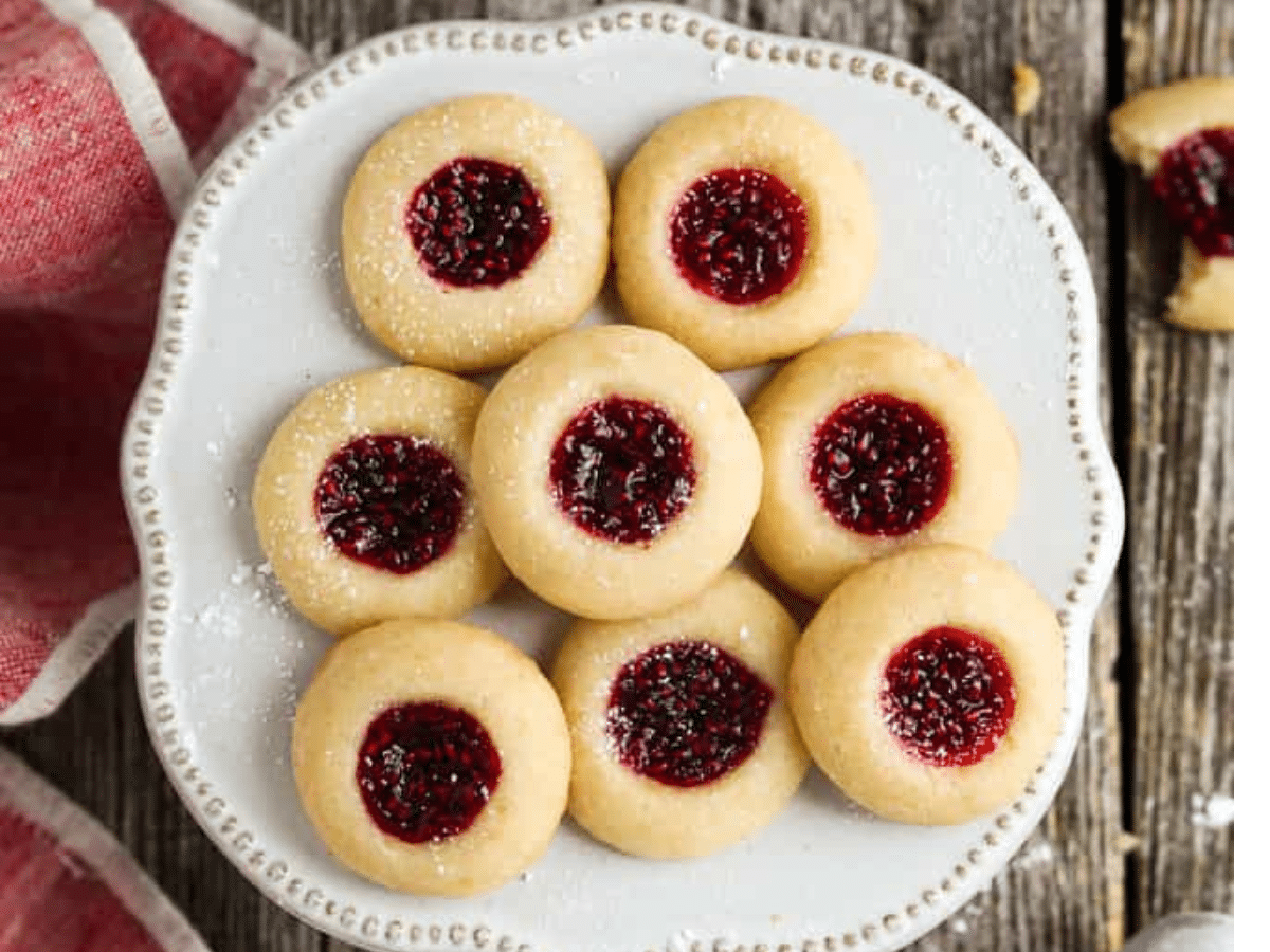 Vegan thumbprint cookies with jam and powdered sugar.
