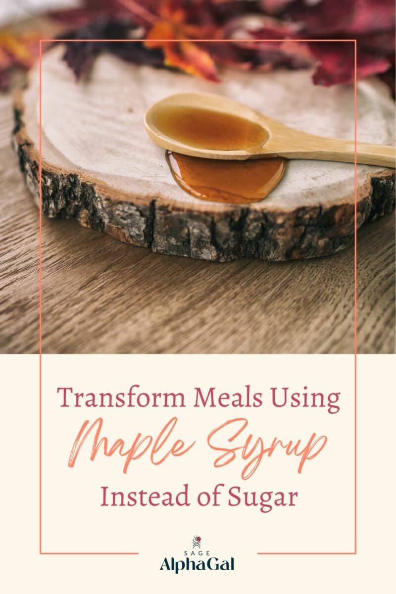 Wooden spoon with maple syrup on a tree slice, surrounded by autumn leaves, with text promoting using maple syrup as a sugar alternative.