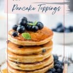 A stack of pancakes topped with fresh blueberries and a mint leaf, accompanied by text promoting fresh and healthy pancake toppings.