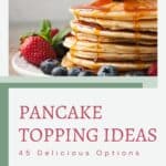 Stack of pancakes topped with blueberries and syrup, accompanied by strawberries, on a light background with text "pancake topping 45 delicious options.